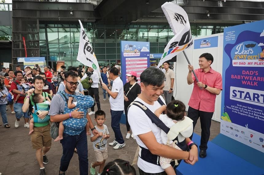 Baby-wearing dads celebrate Fathers' Day with record-breaking walk in S'pore