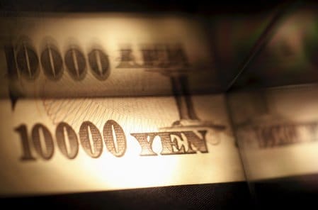 China's yuan falls, tracks yen slide after BOJ decision